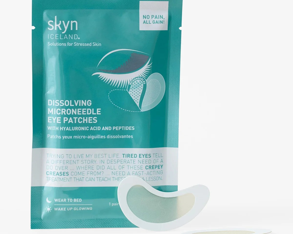 Teal and white packet labeled skyn Iceland Dissolving Microneedle Eye Patches with two curved white hydrogel eye patches.