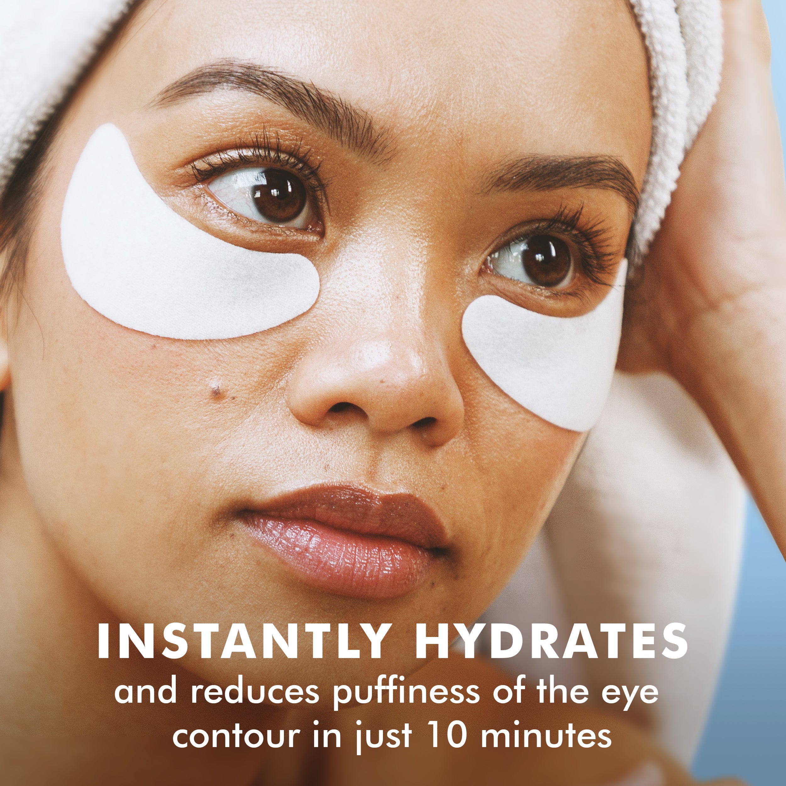 Woman wearing white hydro cool firming eye gels under eyes with headband on brown skin.