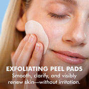 Woman gently applying white exfoliating peel pad to cheek with closed eyes and clear skin.