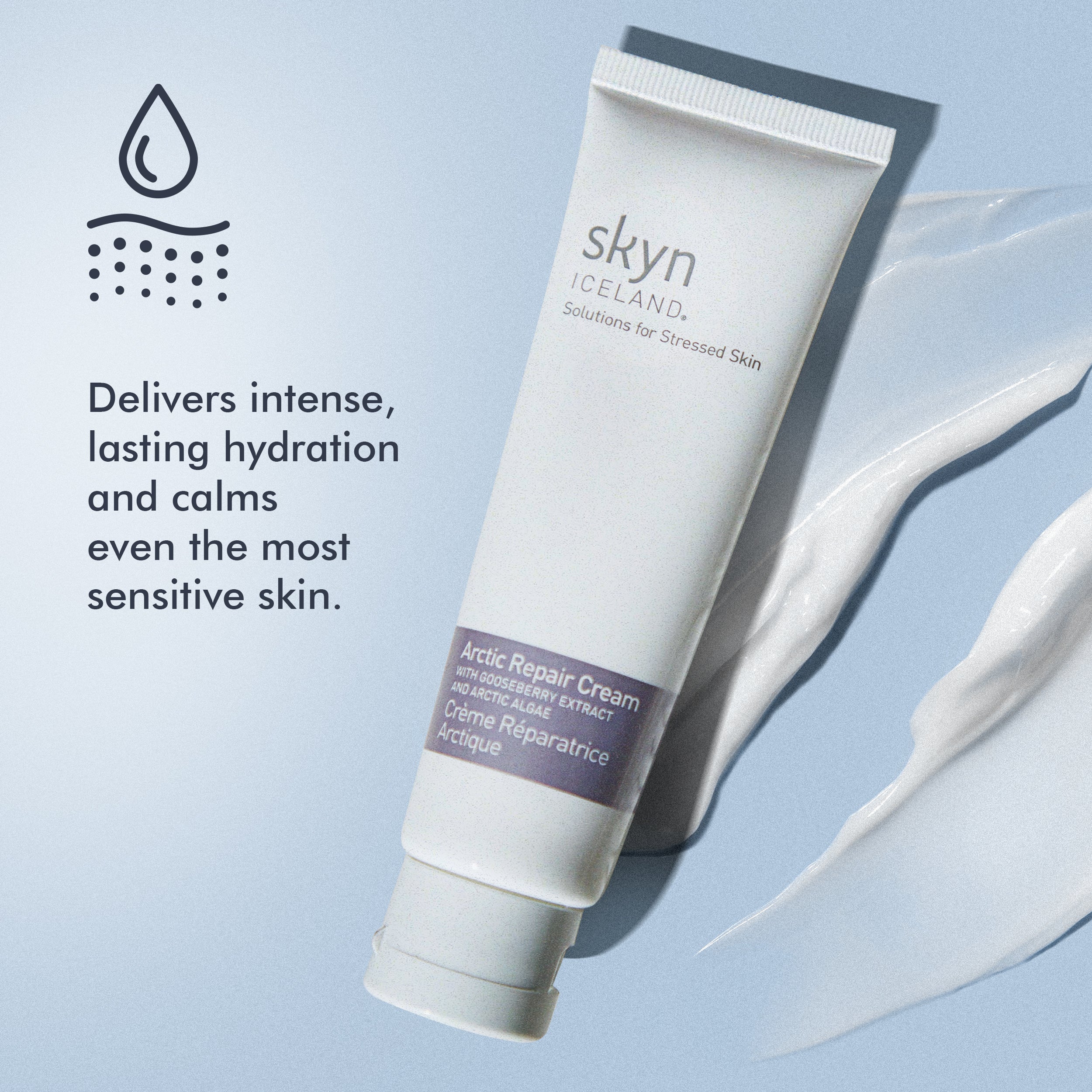 White tube of skyn Iceland Arctic Repair Cream with soft cream smear on light blue background.