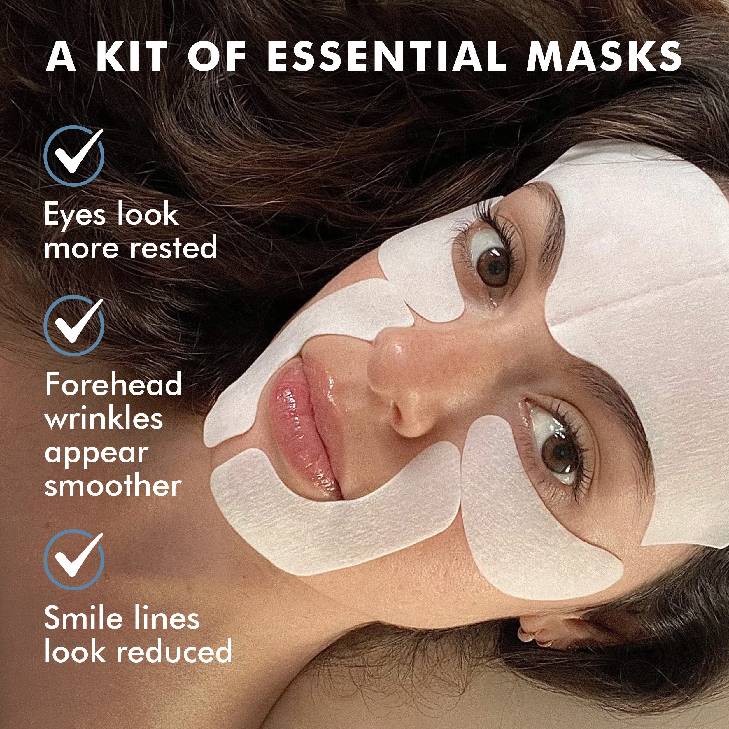 Woman wearing white facial masks targeting eyes, forehead, and smile lines against dark hair background.