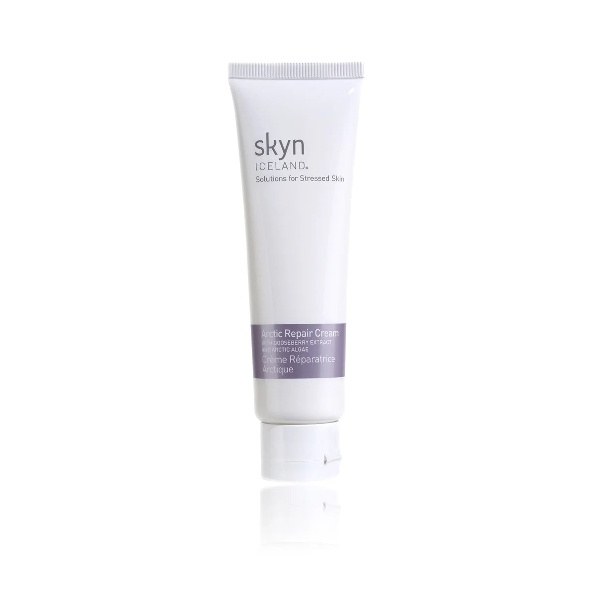 White tube of skyn Iceland Arctic Repair Cream with purple label and white cap on reflective surface.
