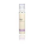 Skyn hydrating daily lotion in a tall white pump bottle with silver and purple accents.