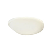 Smooth, white lotion swatch with a creamy texture on a white background.