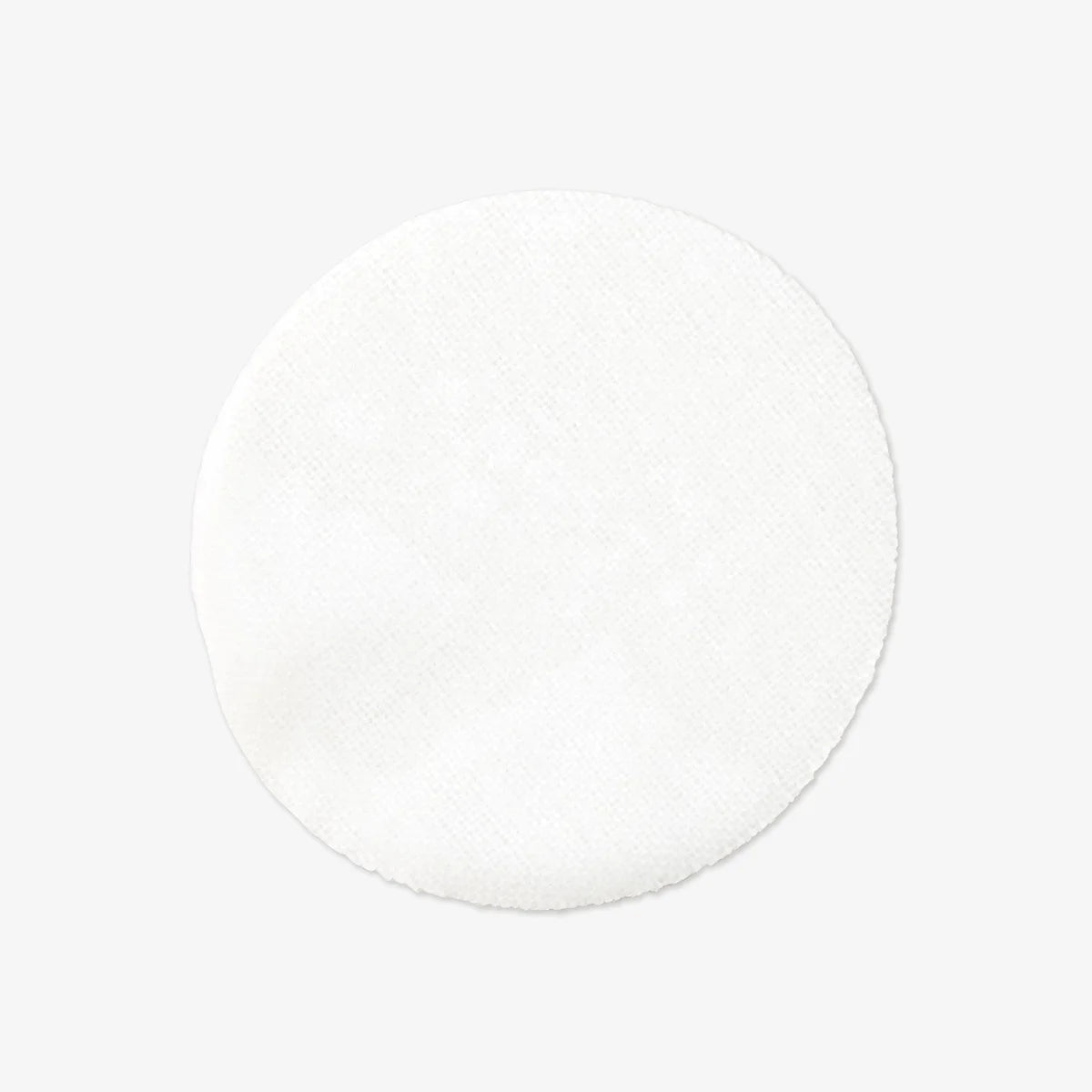 White round cotton pad with soft texture on a light gray background.