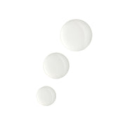 Three white serum droplets of varying sizes on a white background.