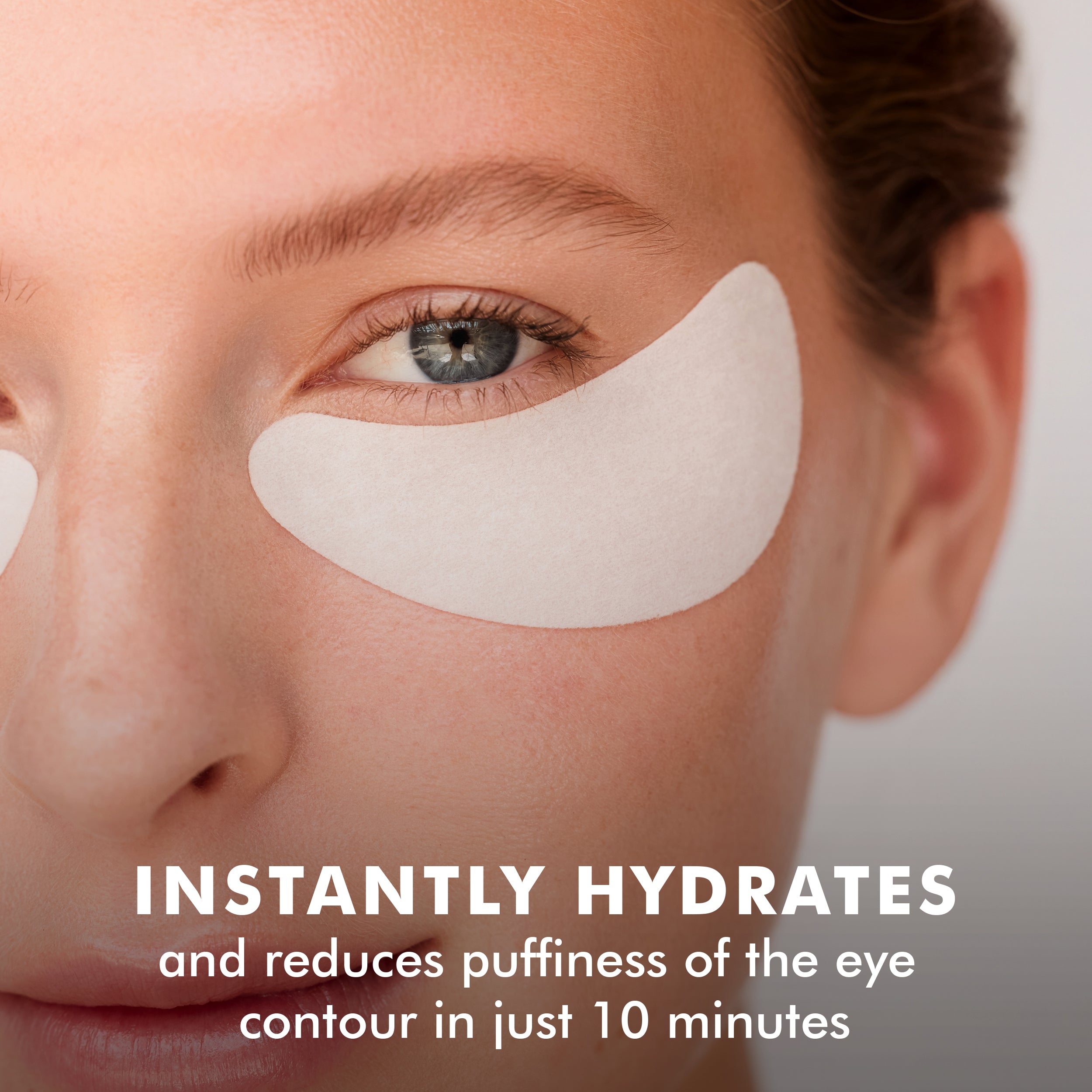 Close-up of a face with a white hydro cool firming eye gel patch under the eye, highlighting hydration benefits.