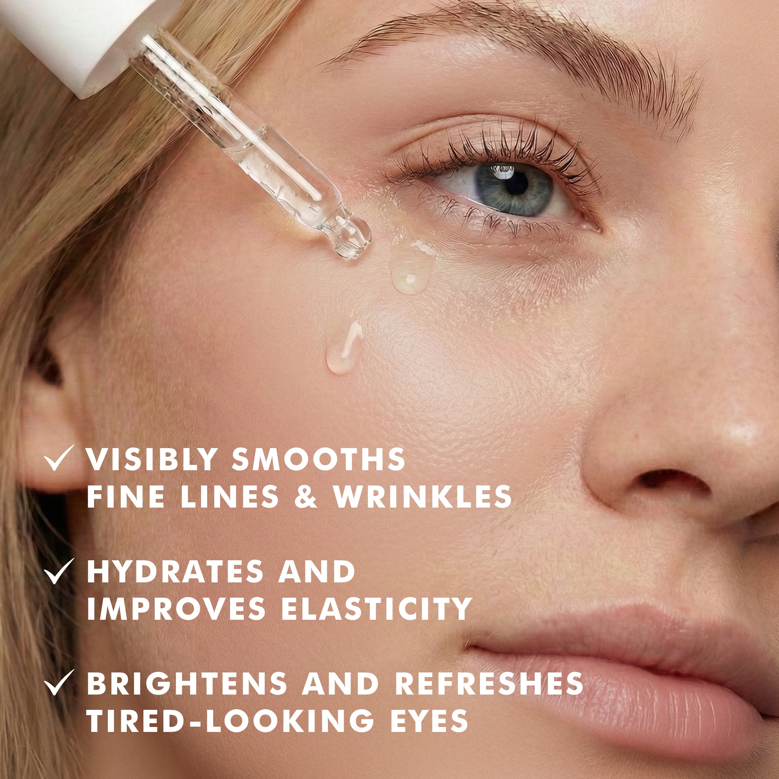 Clear dropper releasing serum onto under-eye skin of a fair-skinned woman with blue eyes and natural makeup.