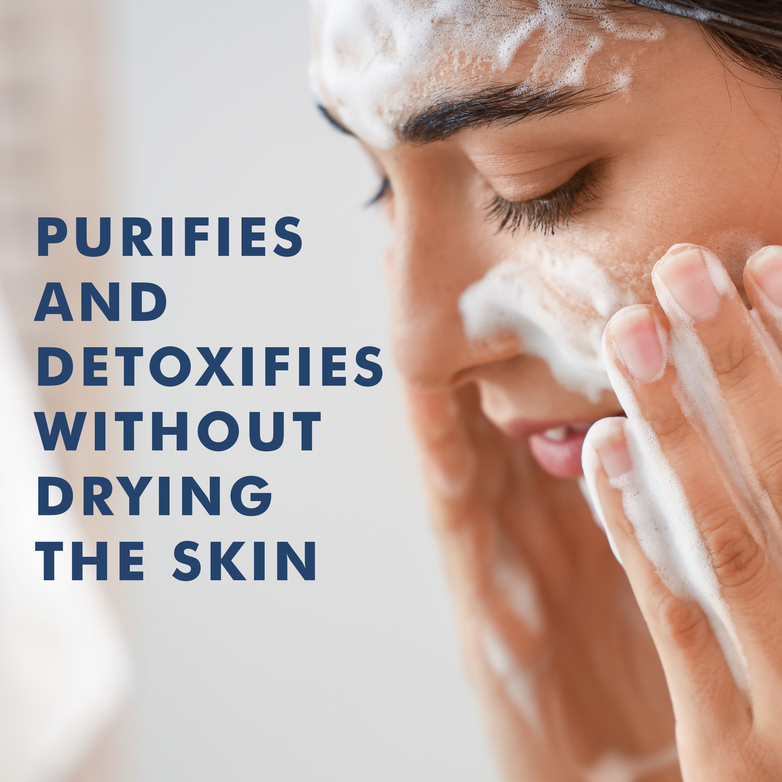 Close-up of woman with foamy white face wash gently cleansing skin.