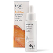 White dropper bottle with black and orange text, labeled BrightSkyn Brightening Eye Serum by Skyn Iceland, next to an orange