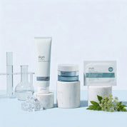 Skyn Iceland Deep Hydration Bundle with white tube, blue jar, soothing gel sachets, and clear glass vessels on white marble.