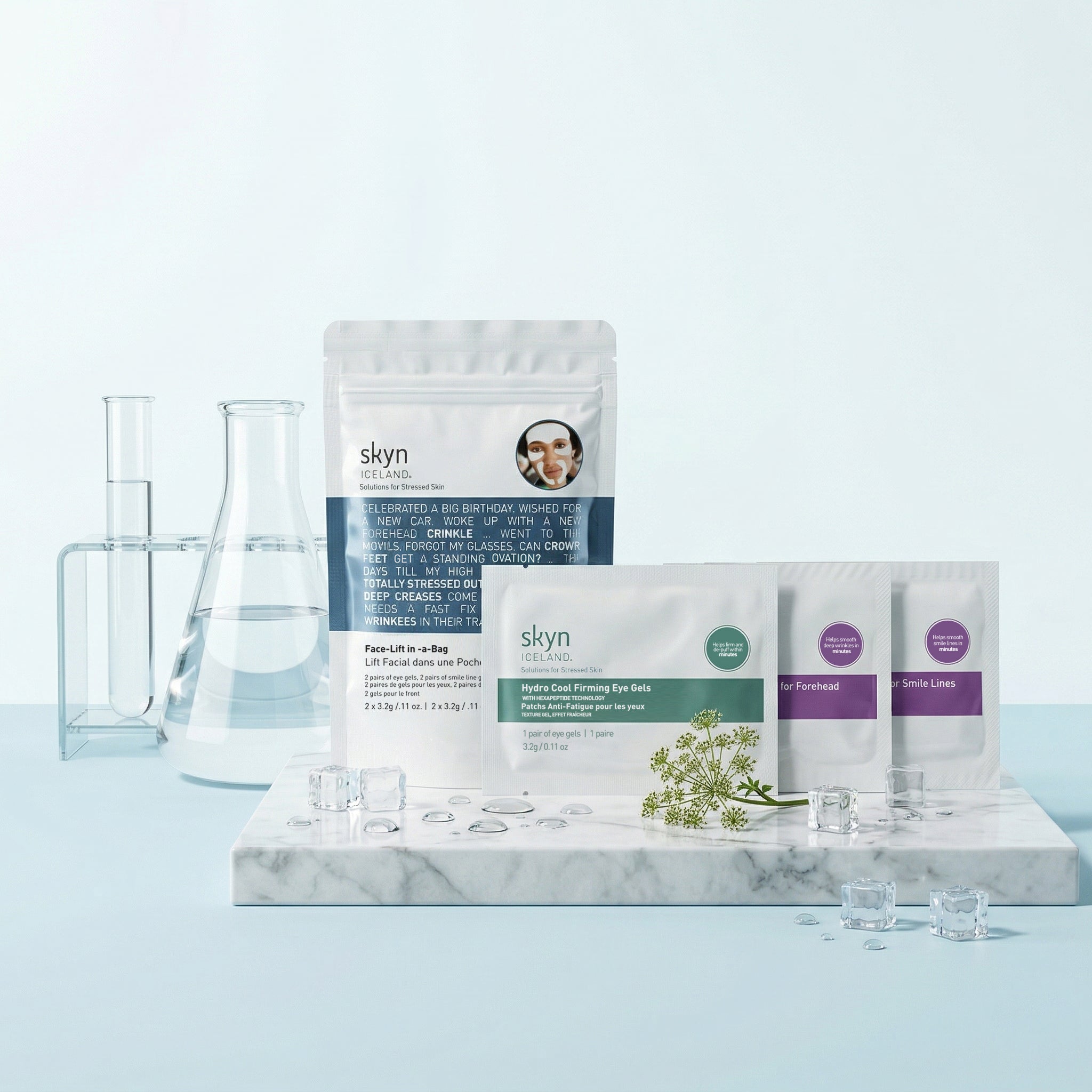 Skyn Iceland Face-Lift in-a-Bag skincare set with three small pouches and a resealable white pouch on marble slab, clear.