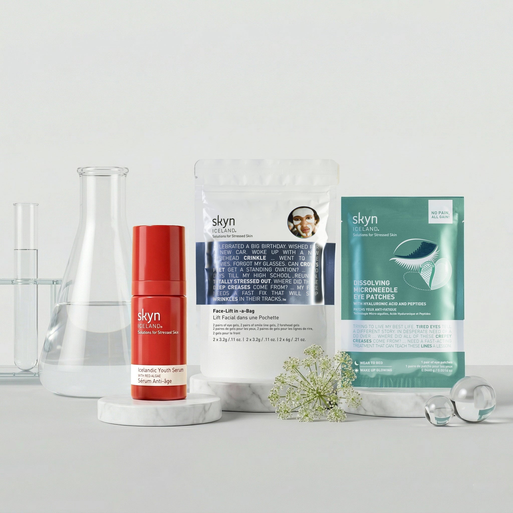 Skyn skincare longevity bundle with red serum bottle, white jar, and green sachet on white surface.