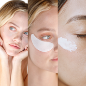 Close-up of woman with light skin applying white cream on cheek, wearing white under-eye gel patches, and resting chin on.